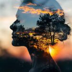 A woman's face with trees and sky in the background